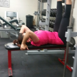 A women using the cable press in a gym